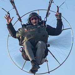 Jean-Pierre Seger, Chief Instructor, flying a paramotor and waving
