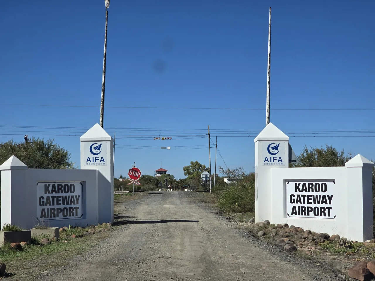 The gate and signs of Karoo Gateway Airport on Day 3