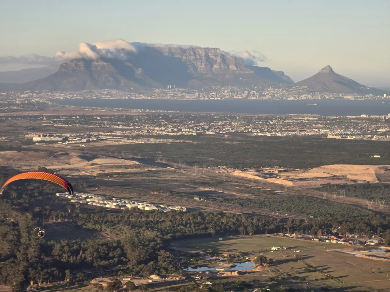 Table Mountain and Table Bay seen from the paramotor on Day 5, with a wing in the corner of the frame